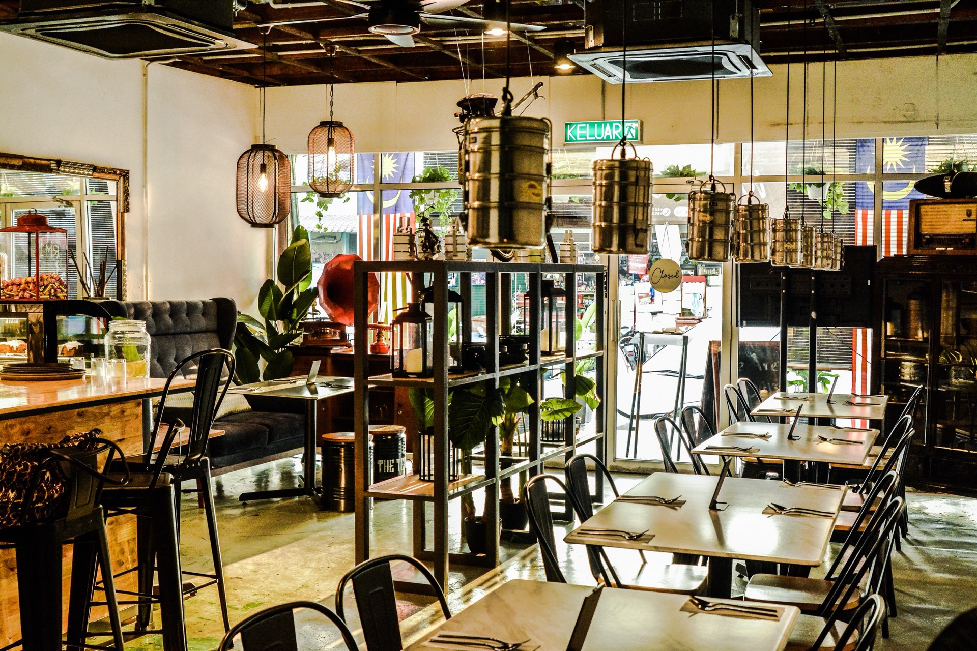 Inside The Tepen — dining room with hanging tiffin carriers, vintage furniture and warm light