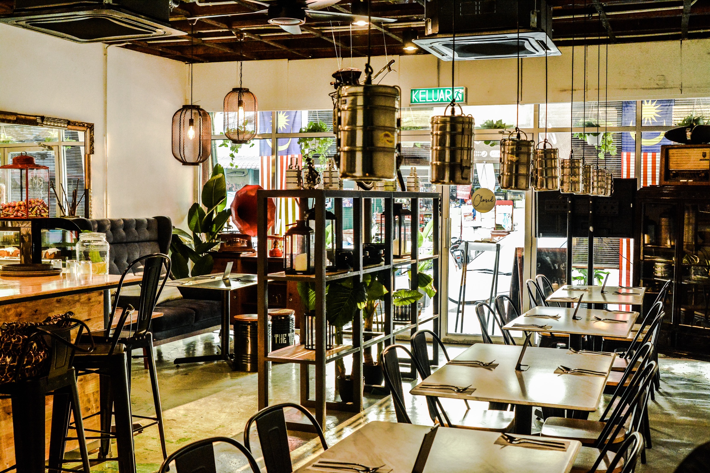 Inside The Tepen — dining room with hanging tiffin carriers, vintage furniture and warm light