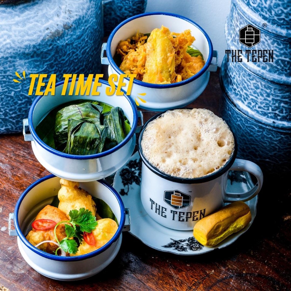 High-tea spread of cakes and savouries served in tiffin tins at The Tepen
